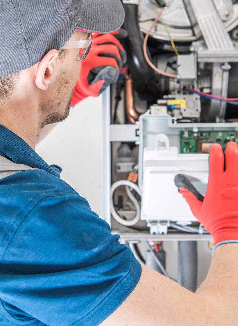 Heating Central Gas Furnace Issue. Technician Trying To Fix the Problem with the Residential Heating Equipment.